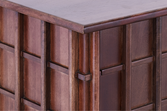 Close-up of the masterfully crafted corner joints and the overlapping grid design on the Quattro storage console.