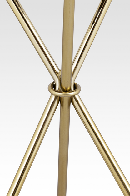 A close-up detail of the Quill End Table’s gold base, highlighting the elegant ring-joint where the three slender legs meet.