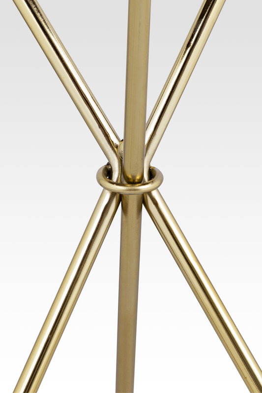 A close-up detail of the Quill End Table’s gold base, highlighting the elegant ring-joint where the three slender legs meet.