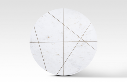 A perfectly circular overhead view of the Ray Coffee Table, showcasing the intricate intersecting geometric brass inlay pattern embedded in the white marble.