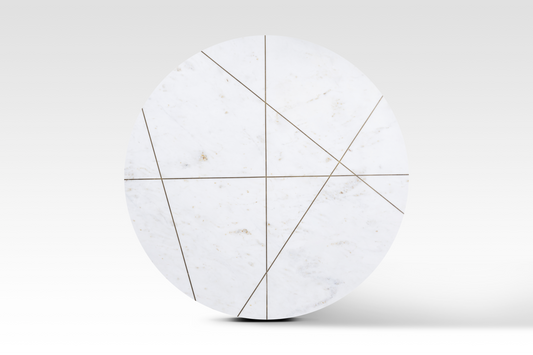 A perfectly circular overhead view of the Ray Coffee Table, showcasing the intricate intersecting geometric brass inlay pattern embedded in the white marble.