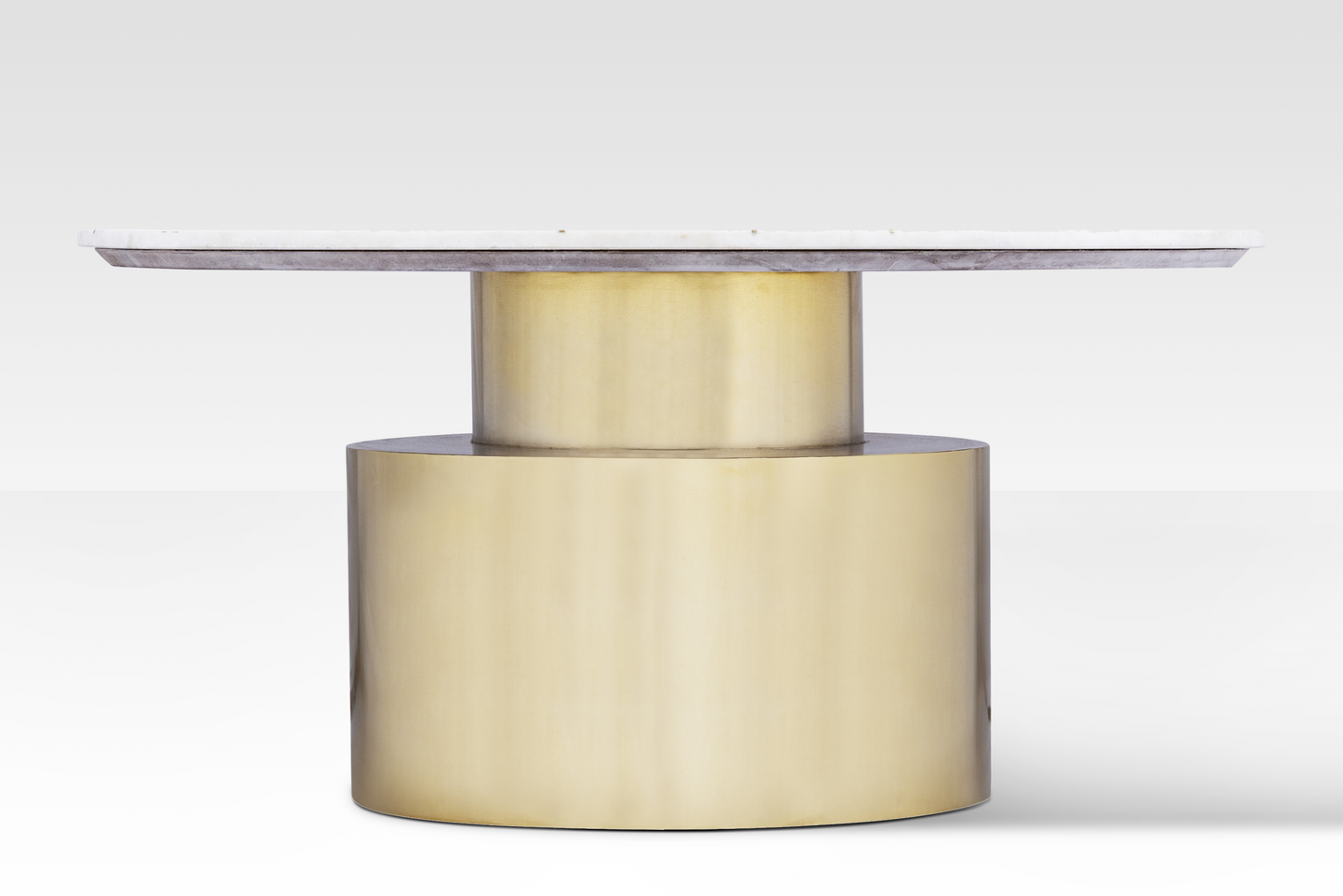 A straight-on profile of the Ray Coffee Table highlighting the architectural two-tier stepped brass base and slim marble top.