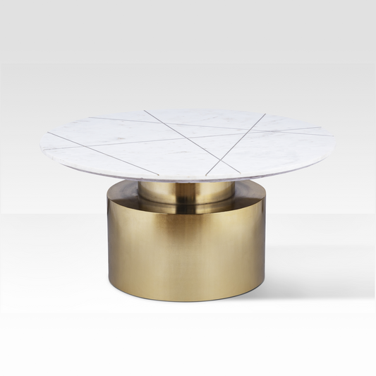 An angled view of the Ray Coffee Table featuring a white marble top with geometric brass inlay lines and a stepped brass pedestal base.