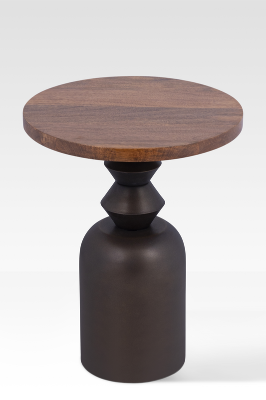 An angled view of the Zentri End Table featuring a circular mango wood top and a sculptural hand-cast metal pedestal base.